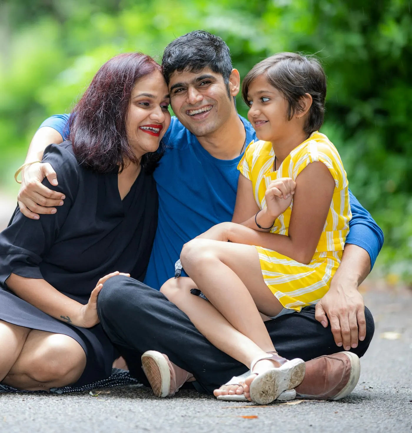 Happy family sitting together outdoors
