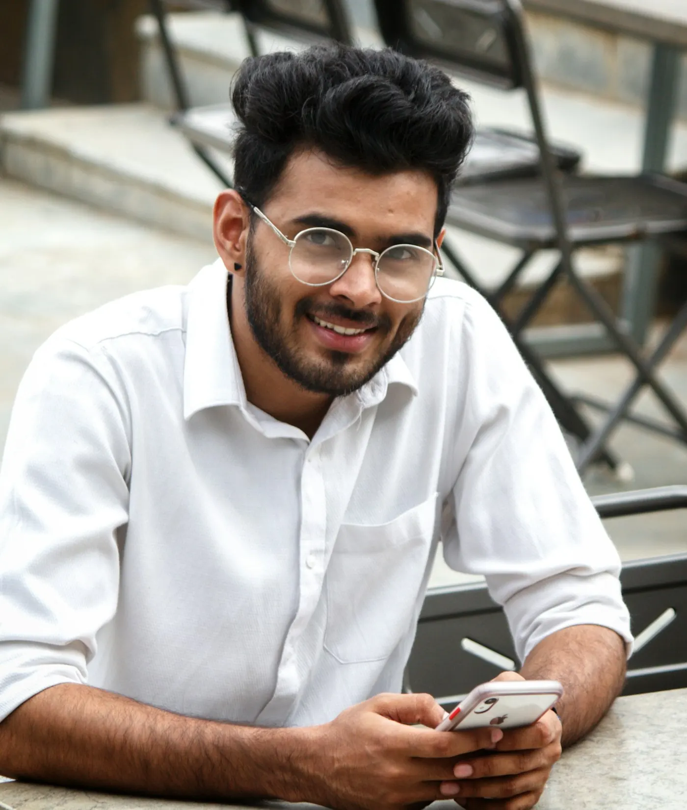 Smiling young professional checking his phone after his personal loan was approved