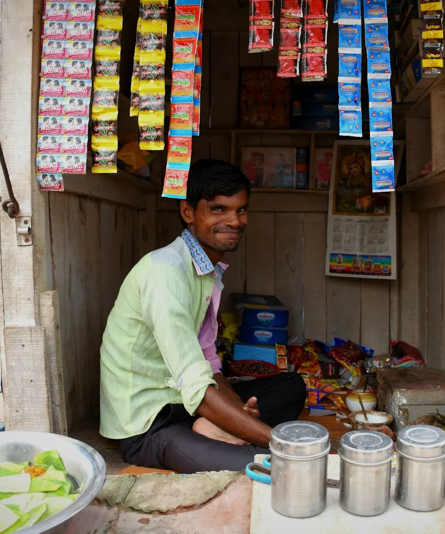Smiling shop owner at his store counter