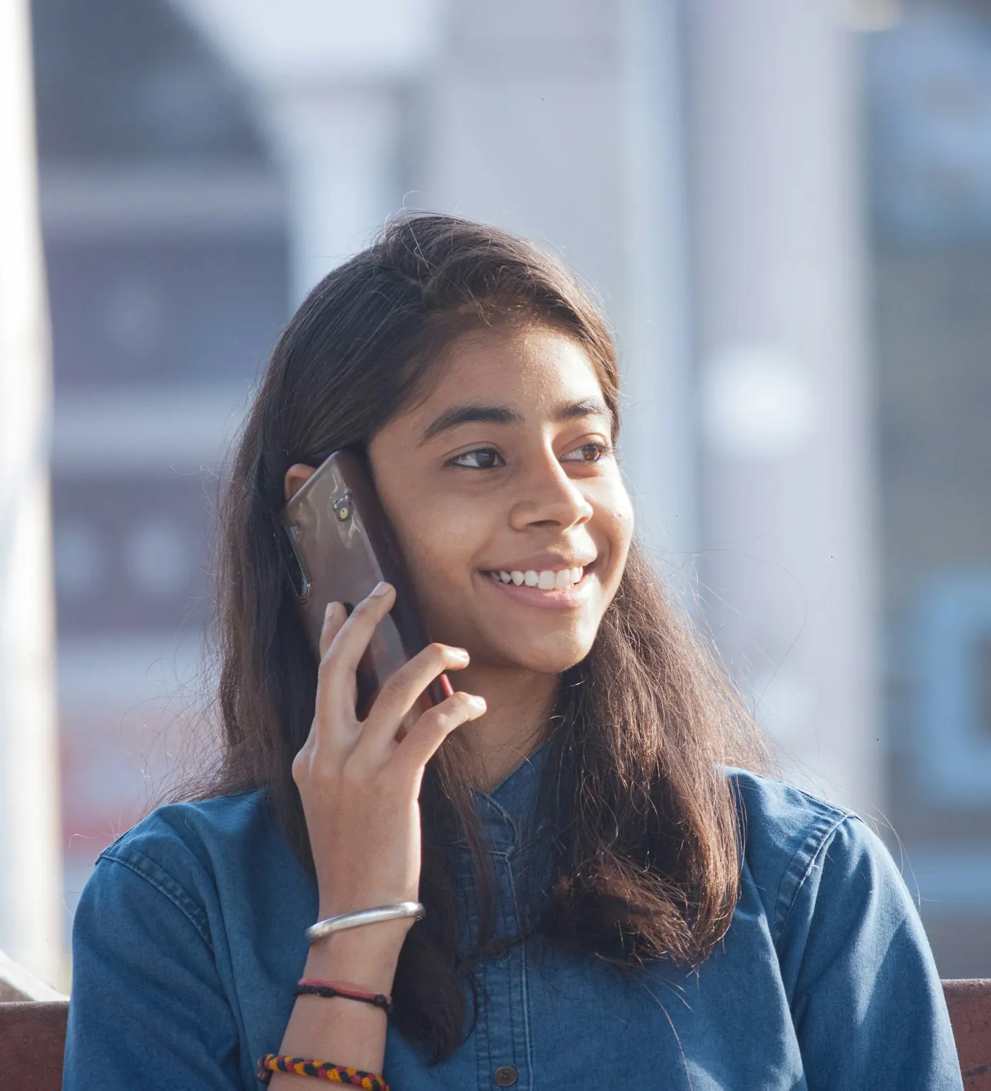 Young woman smiling on a phone call after getting her personal loan sorted