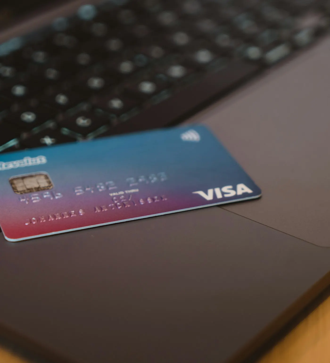 Credit card resting on a laptop keyboard
