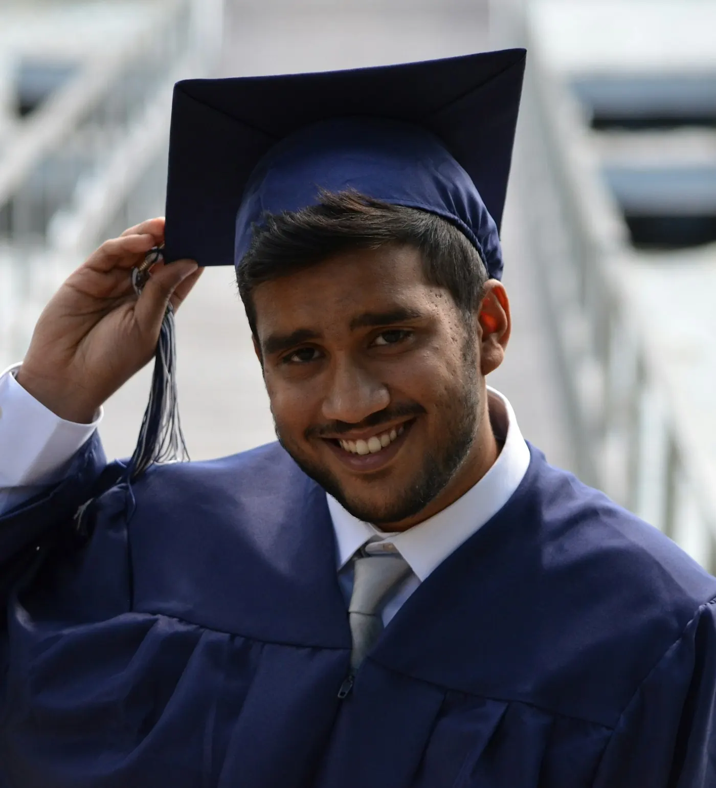 Smiling graduate in cap and gown