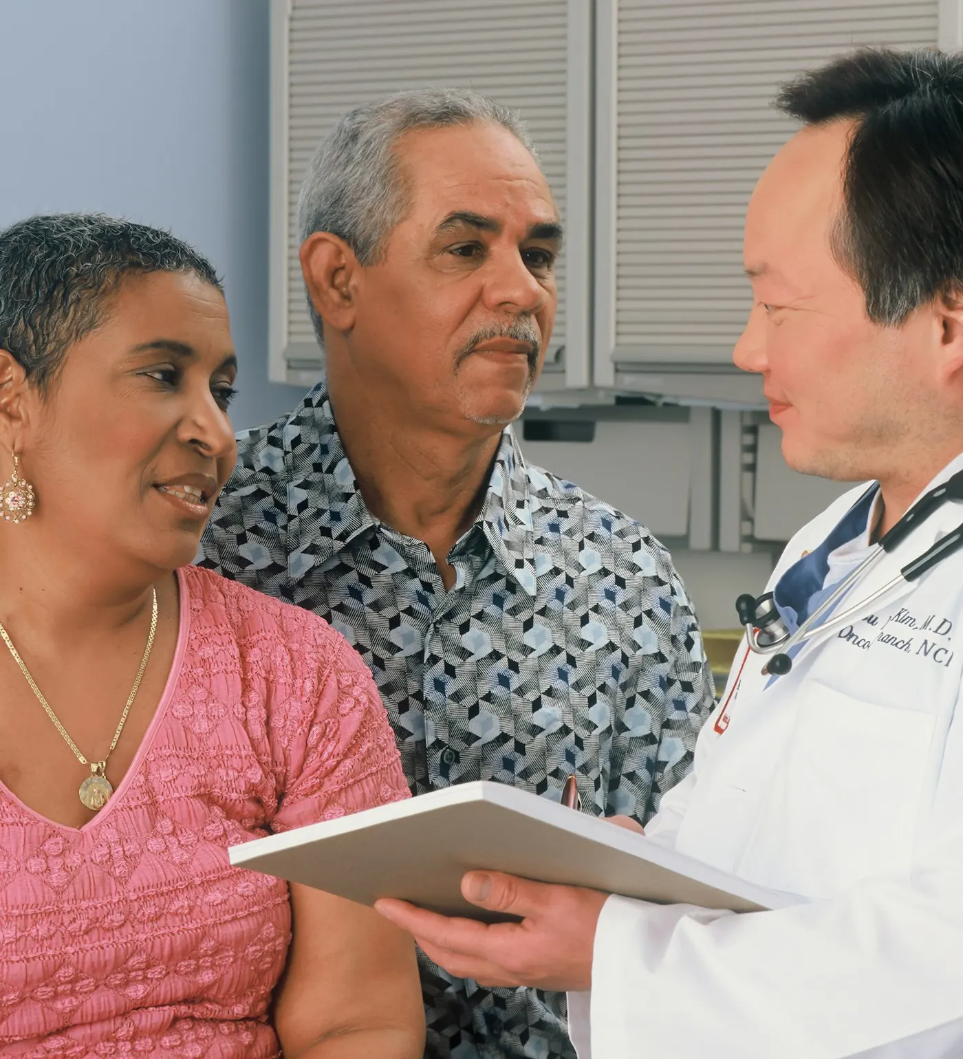 Elderly couple discussing treatment with a doctor