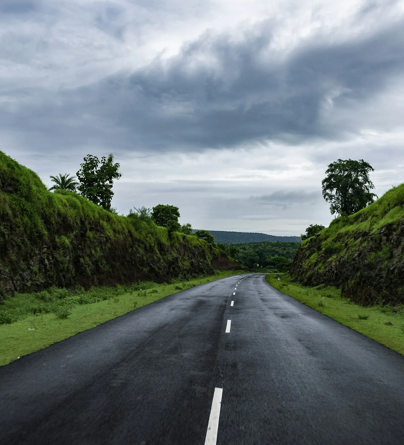 Open road through green hills